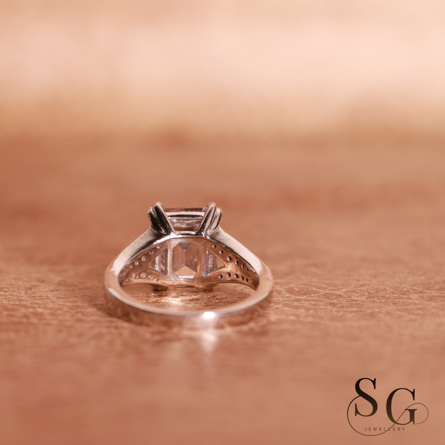 Emerald cut lab grown diamond on 18k white gold band